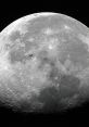 Detailed view of the Moon's surface craters, featuring the International Space Station in the background.