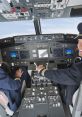 Pilots in cockpit operating controls, showcasing teamwork and precision in flight operations. High-tech aviation dashboard visible.