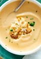 Creamy cauliflower soup topped with roasted cauliflower and fresh herbs, perfect for a delicious meal or appetizer.