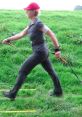 Woman walking energetically on grass with poles, showcasing fitness and agility in outdoor exercise.