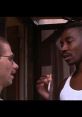 Chauncy from Menace II Society talks with a friend, showcasing intense urban dialogue and street life dynamics.