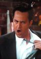 Chandler Bing with an astonished expression, adjusting his tie in a memorable scene from the classic sitcom Friends.