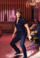 Johnny Castle performing an iconic dance move during a show in "Dirty Dancing," capturing the film's passion and energy.