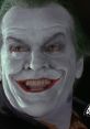 Jack Nicholson's Joker grins menacingly, showcasing iconic makeup in a memorable scene from the classic Batman film.