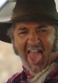 Mick Taylor in "Wolf Creek," showcasing his villainous persona with a fierce expression and tongue out.