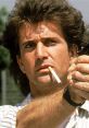 Martin Riggs from Lethal Weapon aiming a gun, cigarette in mouth, showcasing his intense character and 80s action style.