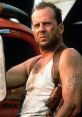 John McClane in a tank top with a gun holster, showcasing his rugged look and determination in "Die Hard.