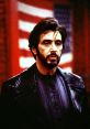 Carlito Brigante from "Carlito's Way," embodying intensity in a dramatic scene with an American flag backdrop.