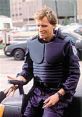 Officer Alex J. Murphy, in tactical gear, prepares for action in a city environment. Iconic portrayal in Robocop.