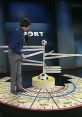 Alan Partridge presents sports predictions with a humorous twist, featuring World Cup 94 themes and a soccer ball display.