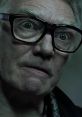 Brick Top from "Snatch" with intense gaze, showcasing his iconic glasses and menacing expression.