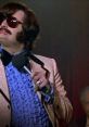 Tony Clifton performing on stage in flamboyant attire, capturing the eccentric essence of "Man on the Moon.