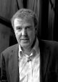 Jeremy Clarkson smiling, wearing a blazer, known for his role in Top Gear and engaging automotive commentary.