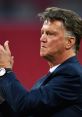 Louis van Gaal applauding during a match as Manchester United's manager, showcasing intense focus and determination.