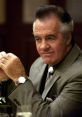 Paulie Gualtieri in a sharp suit, showcasing his iconic mobster style and demeanor from The Sopranos series.