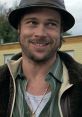 Mickey from "Snatch" smirks, wearing a hat and necklace, capturing his laid-back and charismatic personality.