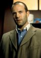 Jason Statham in a sharp suit, showcasing his iconic look from the film "Snatch," embodying a gritty, stylish vibe.