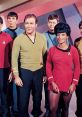 William Shatner and Nichelle Nichols with crew, showcasing iconic costumes from Star Trek: The Original Series.