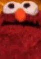 Close-up of a fuzzy red character's face with large eyes and an orange nose, popular in 2019 Earape memes.