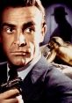 Sean Connery as James Bond in Goldfinger, holding a gun with a golden woman in the background, showcasing classic spy intrigue.