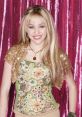 Hannah Montana-inspired costume featuring floral patterns, beads, and sparkling backdrop, showcasing youthful style and charisma.