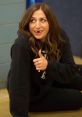 Gina Linetti from Brooklyn Nine-Nine giving a thumbs up with a playful expression, dressed in a black hoodie.