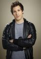 Jake Peralta, the charming detective from Brooklyn Nine-Nine, poses confidently in a stylish leather jacket.