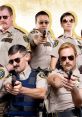 Reno 911! characters in uniform aiming guns, showcasing comedic police antics and unique personalities in a group pose.