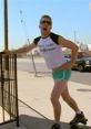 Terry Bernadino from Reno 911! striking a playful pose in colorful shorts and a tank top, showcasing a humorous moment.