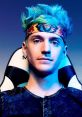 Ninja Fortnite streamer with blue hair and a red bull headband, focused on gaming in a stylish ergonomic chair.