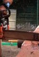 Close-up of a chainsaw cutting through wood, showcasing chainsaw effects and flying debris in a workshop setting.