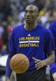 Kobe Bryant warming up with a basketball, wearing a Los Angeles Basketball shirt, showcasing his iconic style and skill.