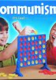 Children enjoying a colorful board game titled "Communism: It's Cool," featuring bright tokens and enthusiasm.