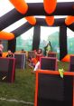 Exciting outdoor fun with friends in a vibrant inflatable arena, featuring colorful barriers and playful action.