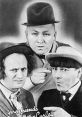 The Three Stooges in classic pose, featuring Larry, Moe, and Curly with playful expressions and iconic hats.