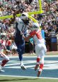 NFL player catches a touchdown pass while being defended during a pro football game, showcasing athleticism and skill.