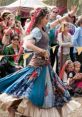 Colorful dancer in vibrant attire entertains a lively crowd at a festival, showcasing cultural celebration and energy.