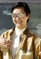 Mr. Chow in stylish sunglasses, smiling, showcasing his iconic look from The Hangover in a desert setting.