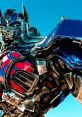 Close-up of Optimus Prime showcasing his iconic blue and red armor under a clear sky, signifying strength and heroism.