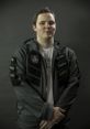 AdmiralBulldog in a stylish esports jacket, showcasing team logos and branding, representing Dota 2 gaming culture.