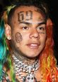 Tekashi 6ix9ine with colorful hair and prominent tattoos, showcasing his iconic style and bold artistry.