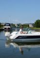 Young man steering a Sea Star 480 boat in calm waters, surrounded by scenic waterfront homes and a clear blue sky.