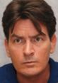 Charlie Sheen with a serious expression, showcasing his iconic look in a dark shirt. Actor known for his roles in comedy series.