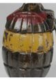 Vintage grenade with a yellow band and black and red paint, showcasing its unique design and historical significance.