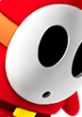 Close-up of a Shy Guy character from Mario Party 5, showcasing its iconic red color and signature white mask.