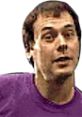 Dan Forden, known for Mortal Kombat 4, features a casual expression in a purple shirt, showcasing his distinctive personality.