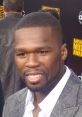 50 Cent smiling at the American Music Awards, showcasing his stylish suit and charismatic presence at a major music event.