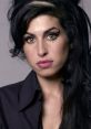 Close-up portrait of Amy Winehouse featuring her signature eyeliner and iconic hairstyle, exuding her unique style.