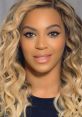 Beyoncé with wavy blonde hair and natural makeup, showcasing her radiant smile and captivating eyes.