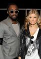 Will.i.am and Fergie of the Black Eyed Peas showcase stylish looks at a public event, exuding confidence and charisma.